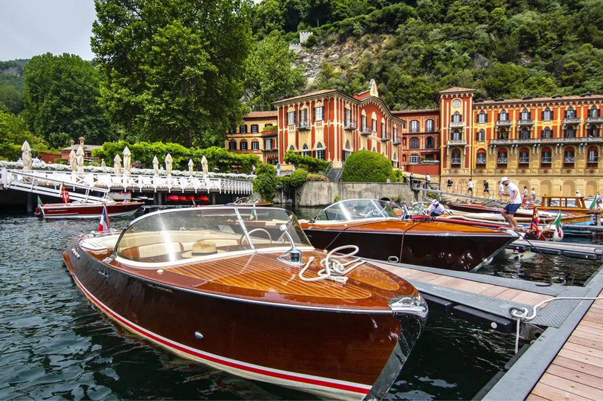 Moored wooden boats on the lake near the palazzo waterfront