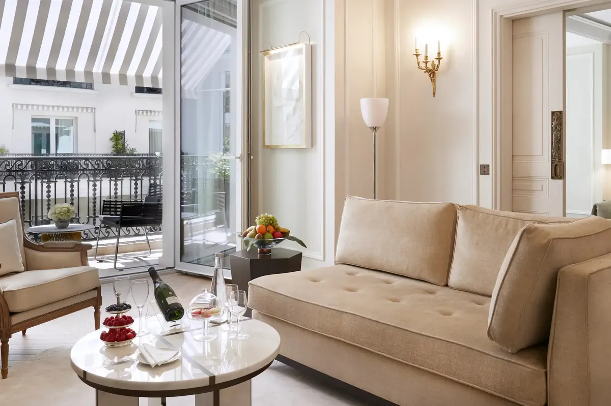 Suite sitting area with upholstered seating overlooking Monaco’s palace