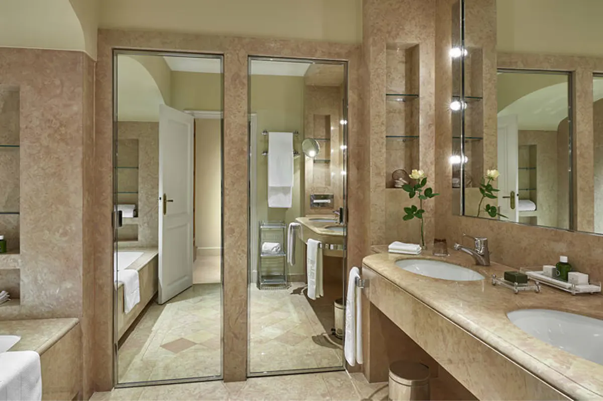 Spa bathroom with marble finishes and vanity lighting