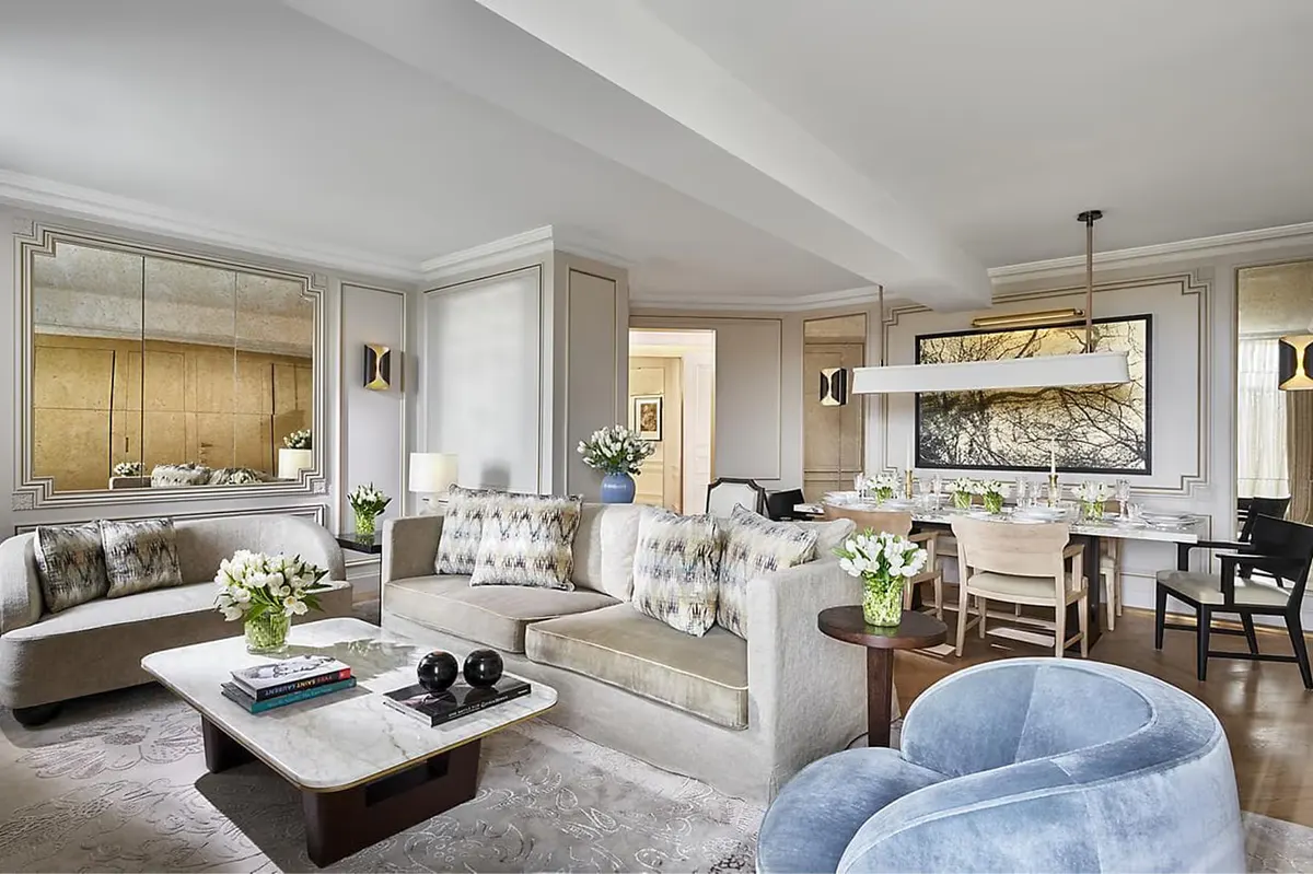 Suite with integrated seating, workspace, and soft furnishings in neutral tones