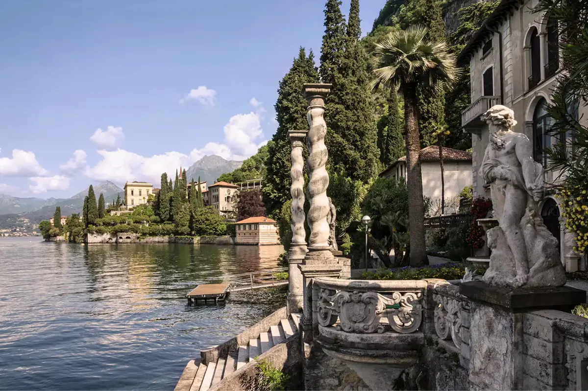Grand stone villa gardens with statuary and waterfront colonnade