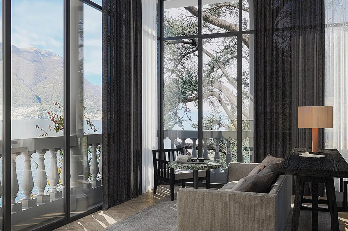 Suite with black drapery, gray seating, and expansive view to mountains and lake