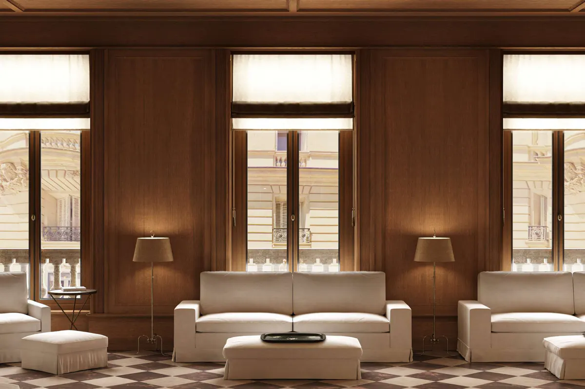 A wood-paneled living room with cream seating and art on the walls