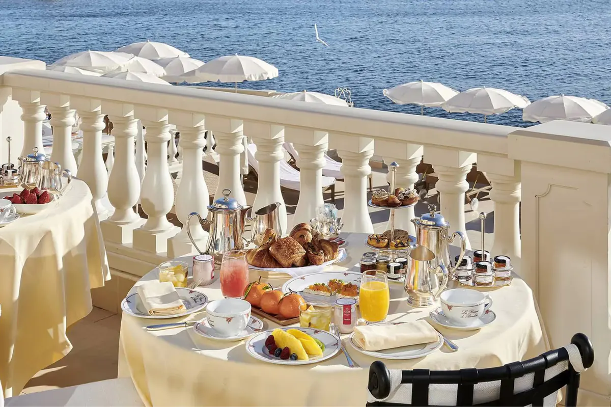 Seaside breakfast table with fresh fruit and water views