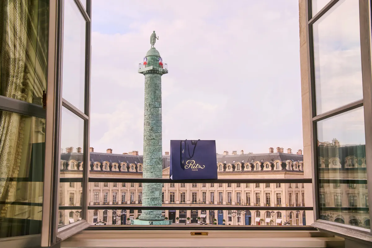 The Vendôme Column framed through French doors from a suite window