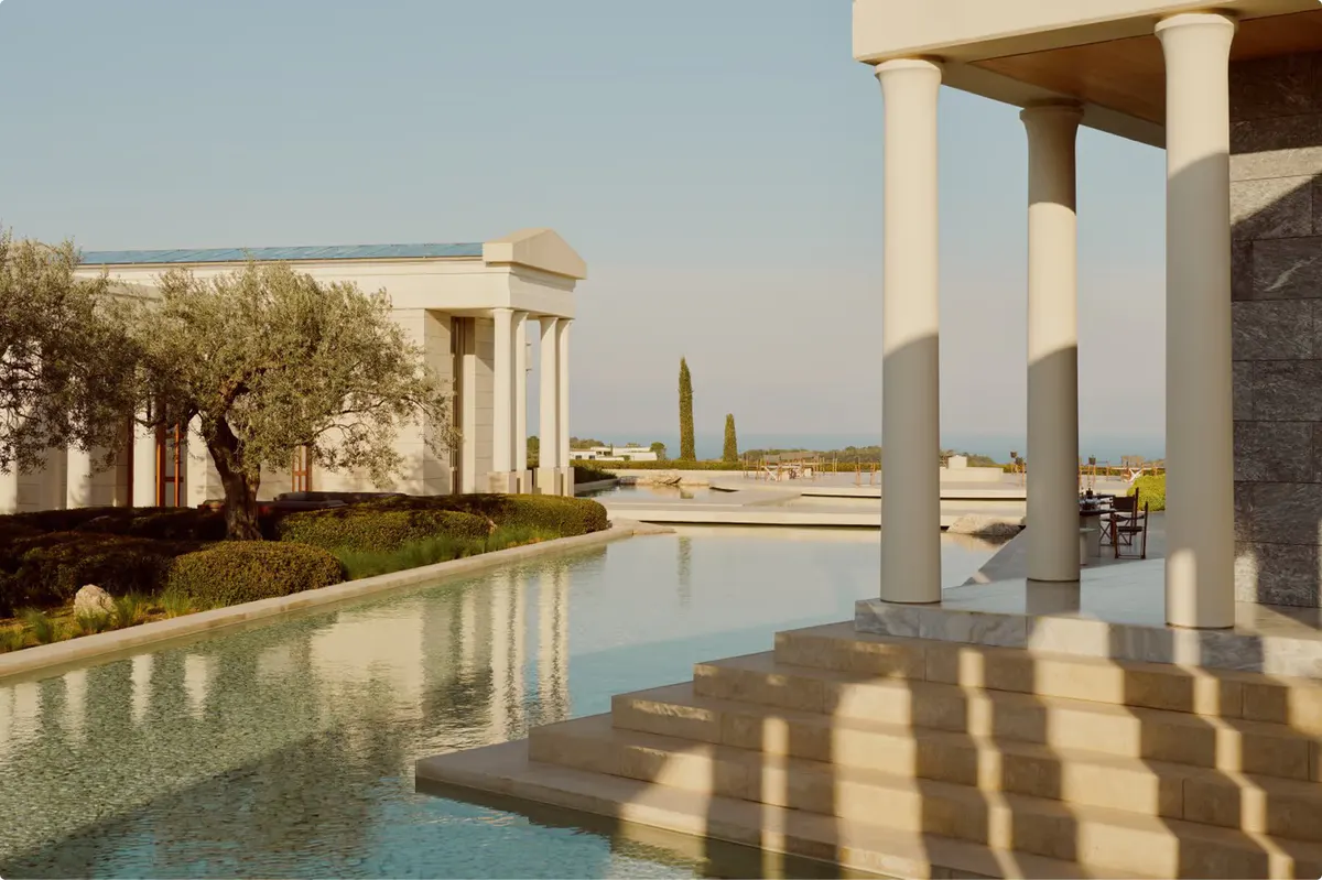 Covered lounge area with cypress plantings and sea views