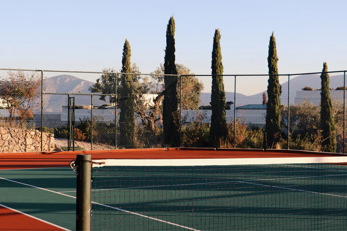 Tennis court overlooking the Aegean with cypress trees