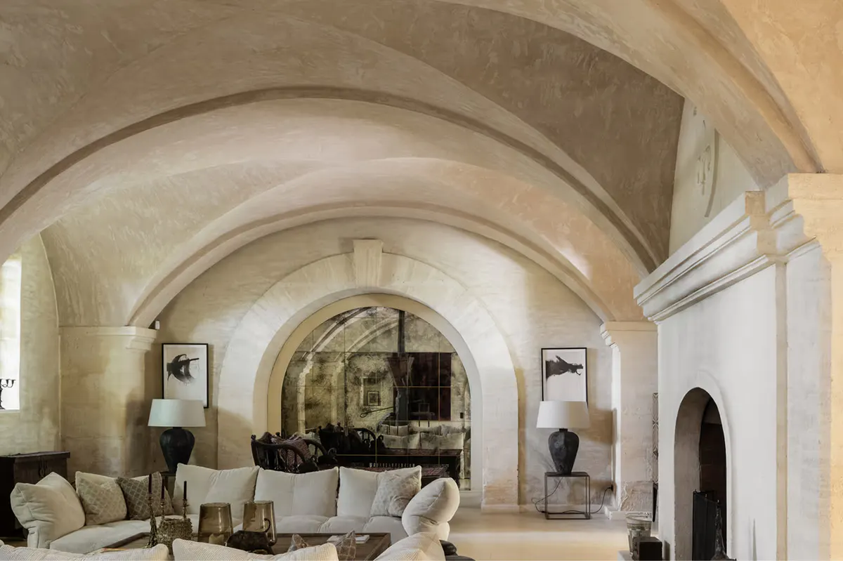 Vaulted barrel ceiling in limestone with generous seating and natural light from side openings
