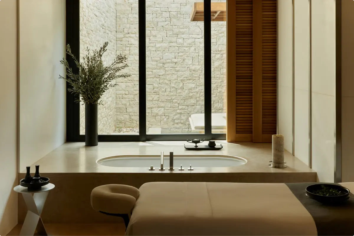 Spa bathroom with soaking tub and bright window opening