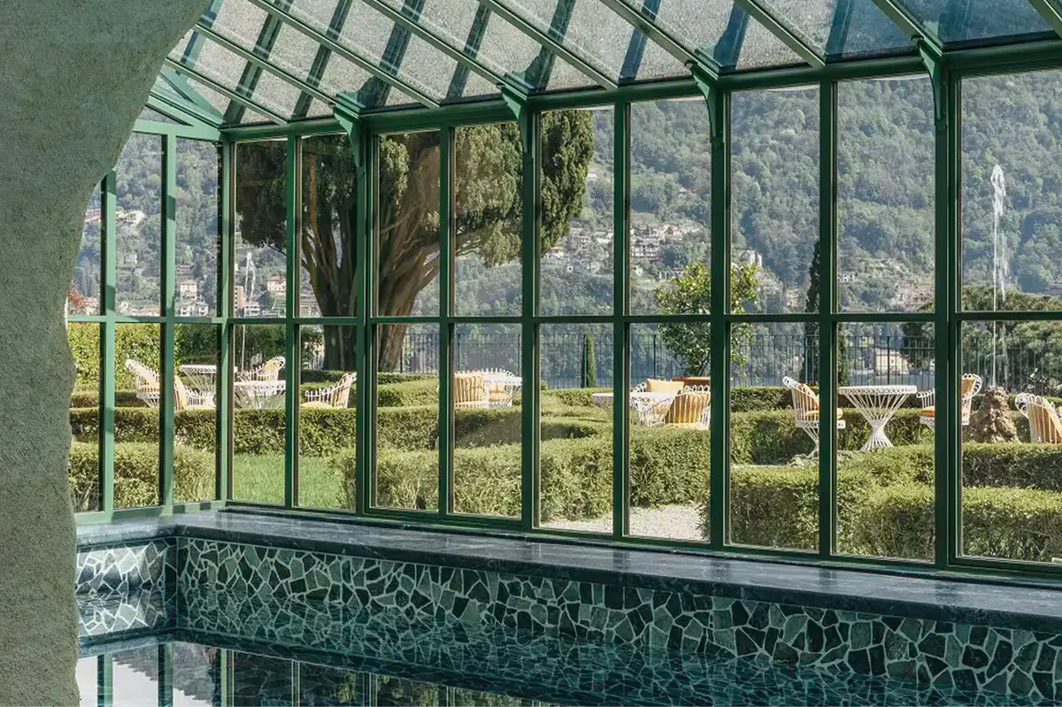 Large windows framing an expansive view of terraced grounds and distant lake