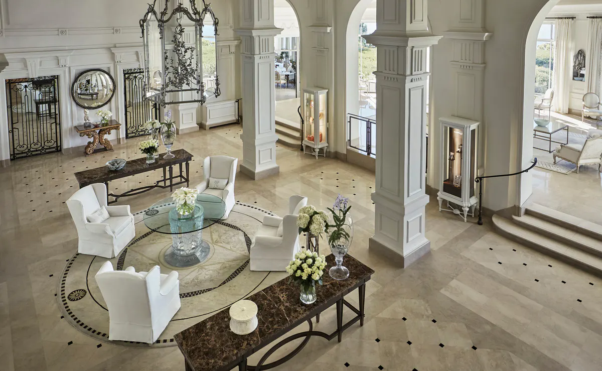 Grand foyer with classical columns, marble floors, and symmetrical layout