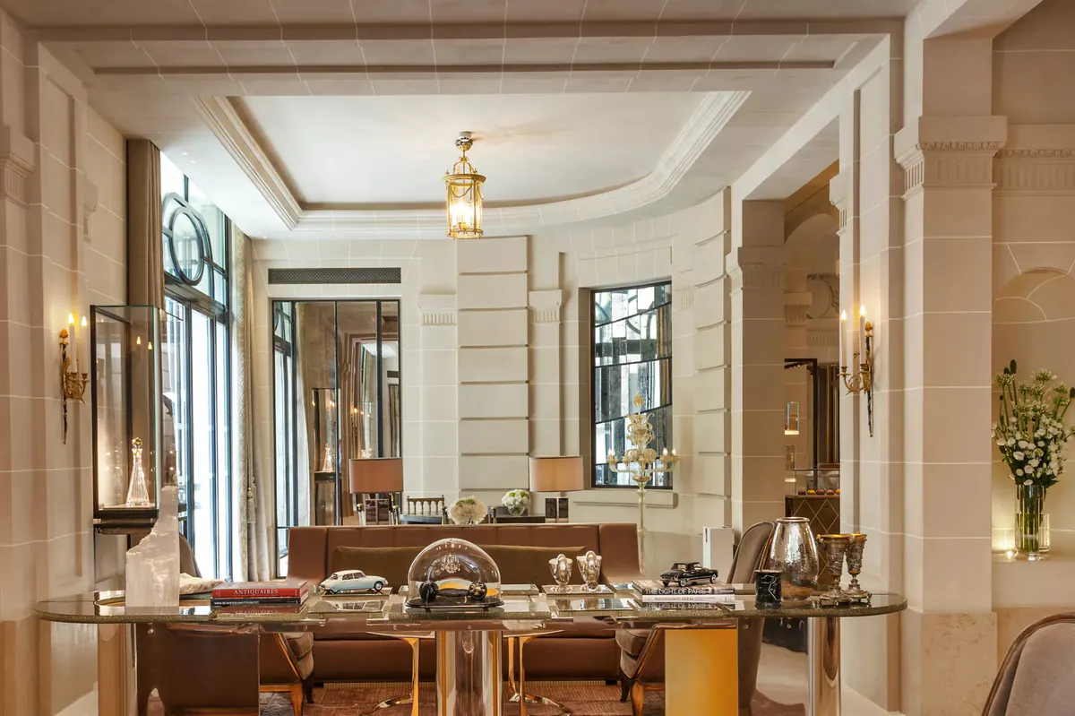 Elegant reception area with marble surfaces, gold accents, and classical proportions