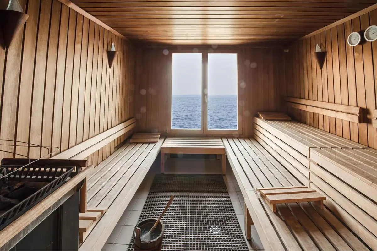 A sauna interior with wooden panels and views through glass