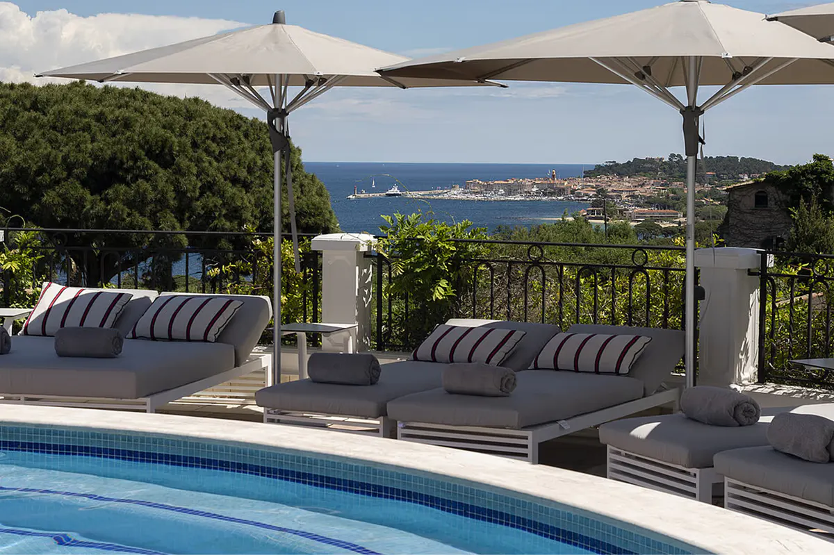 Poolside cabana terrace overlooking the coast under a cantilever shade