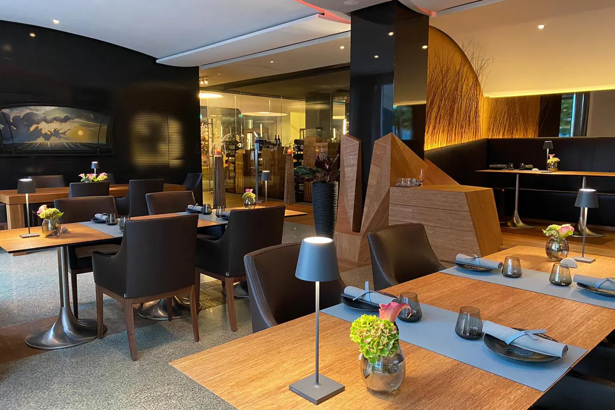 Contemporary dining space with dark wood and warm lighting