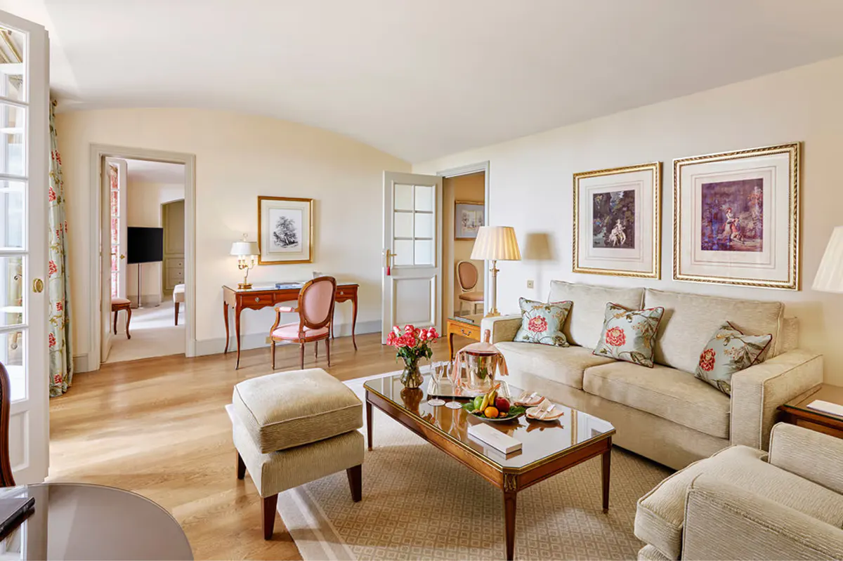 Spacious suite with living area and neutral upholstered seating