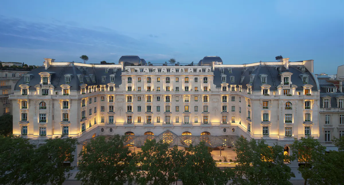 Mansard rooflines and stone facade of the historic building at golden hour