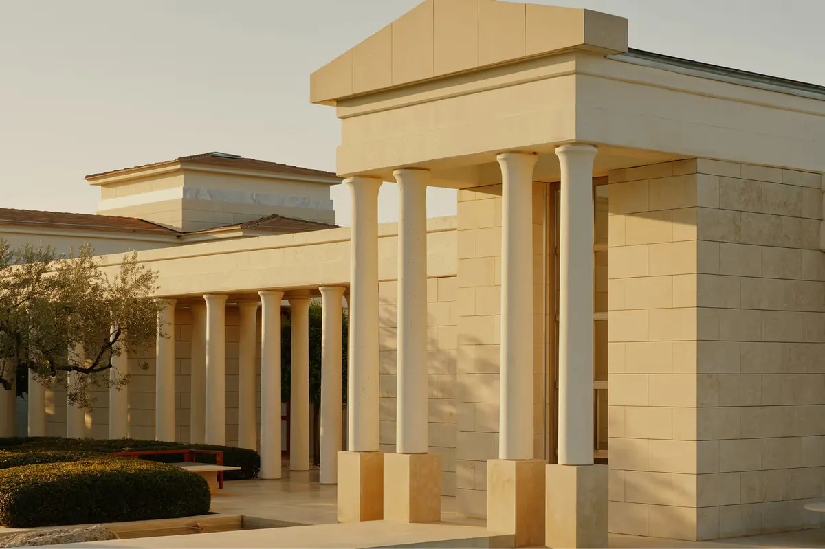 Stone villa exterior with classical pillar details at sunset