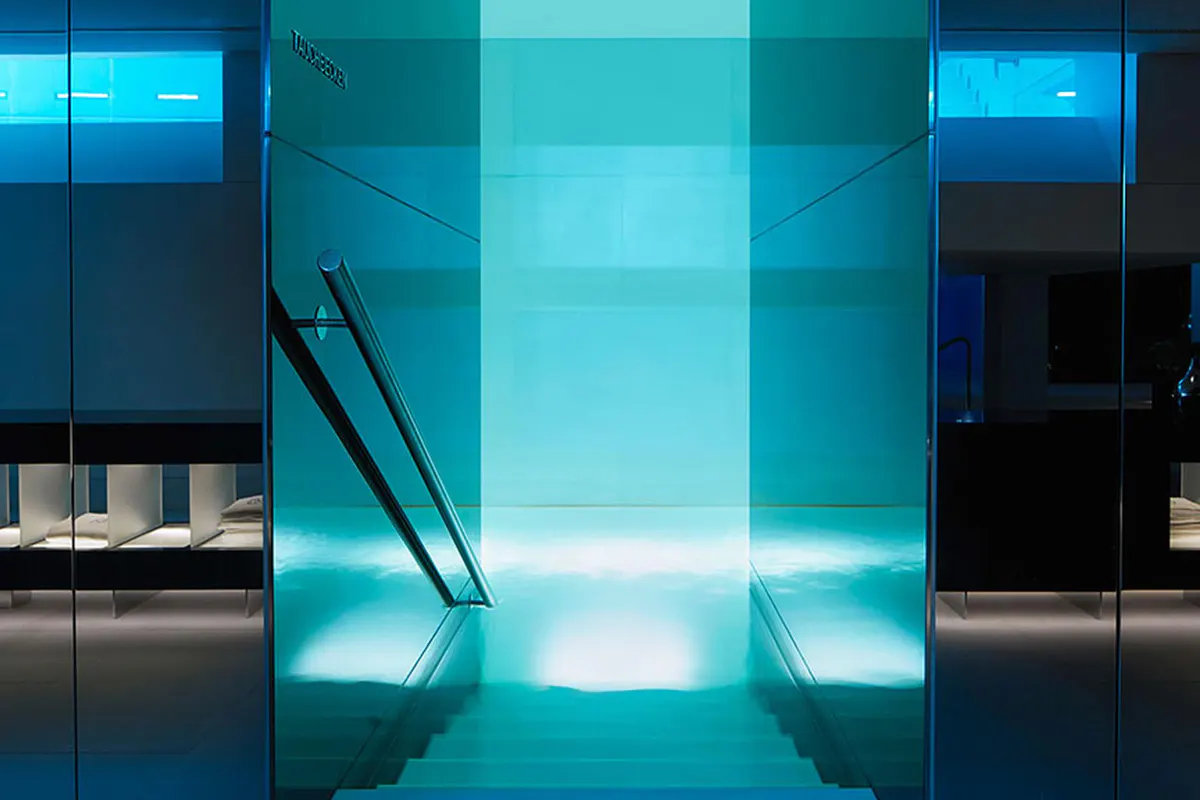 Spa relaxation pool with tranquil turquoise water and glass architecture