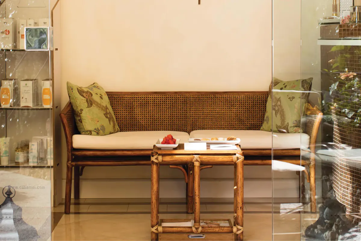 A spa treatment room with warm lighting and massage bed