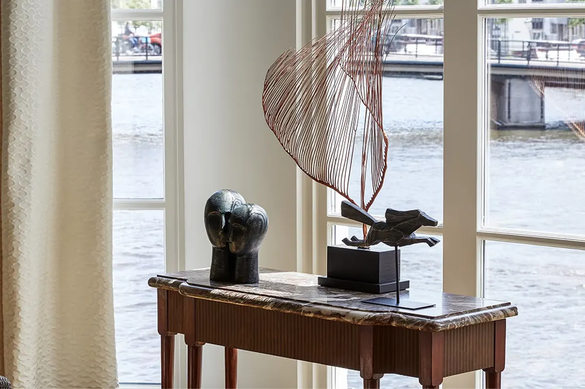 Desk with sculptural arrangement overlooking the Amstel River