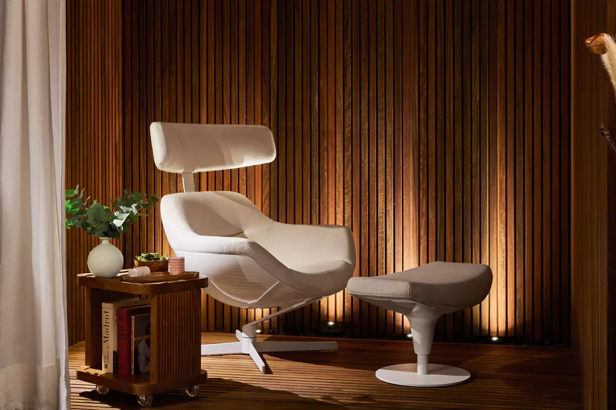 A spa relaxation area with cream-colored lounge chairs and warm wood accents