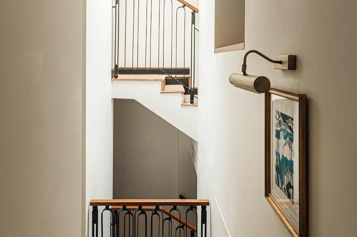 Stairwell with iron railings and framed artwork