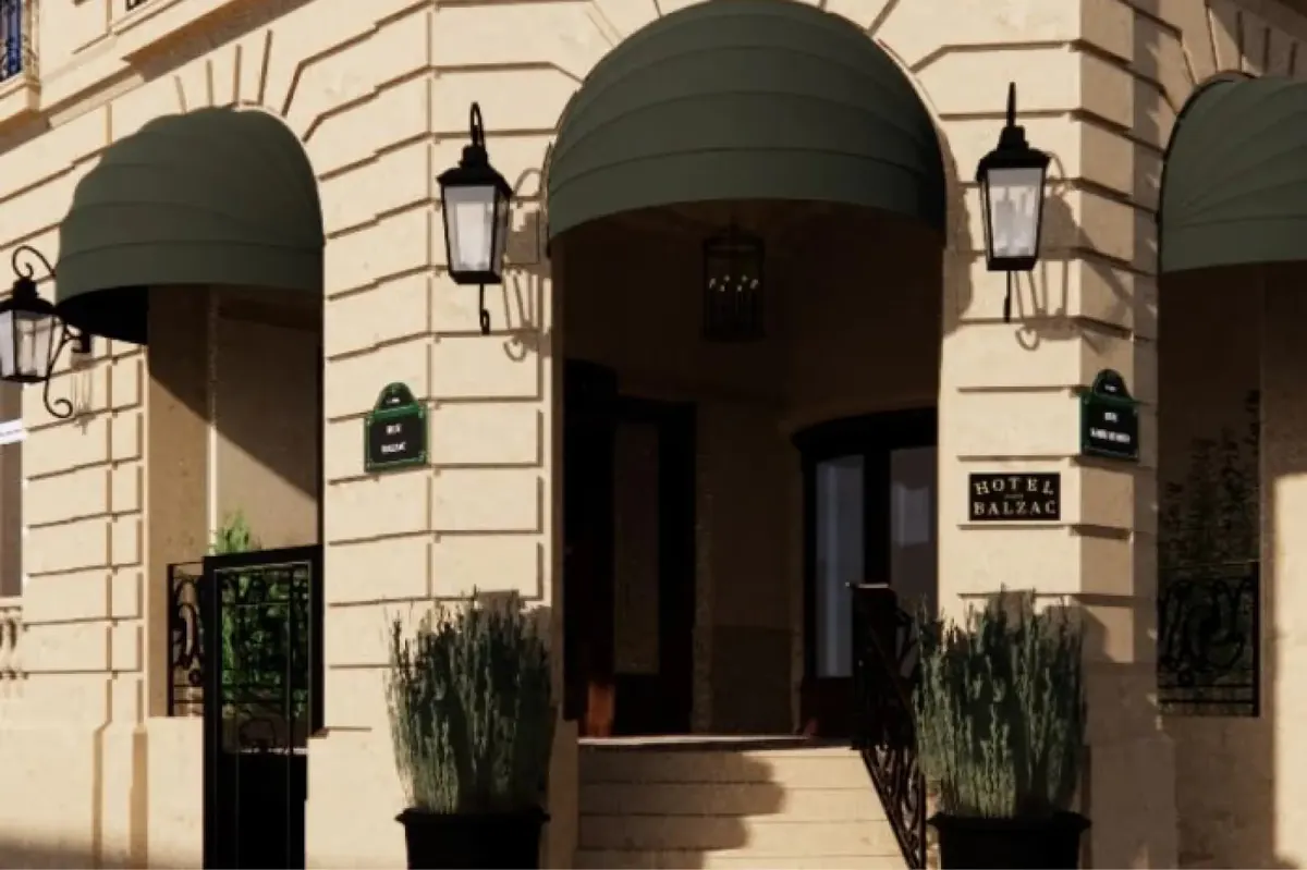 The building’s arched entrance on the street with ivy and lanterns