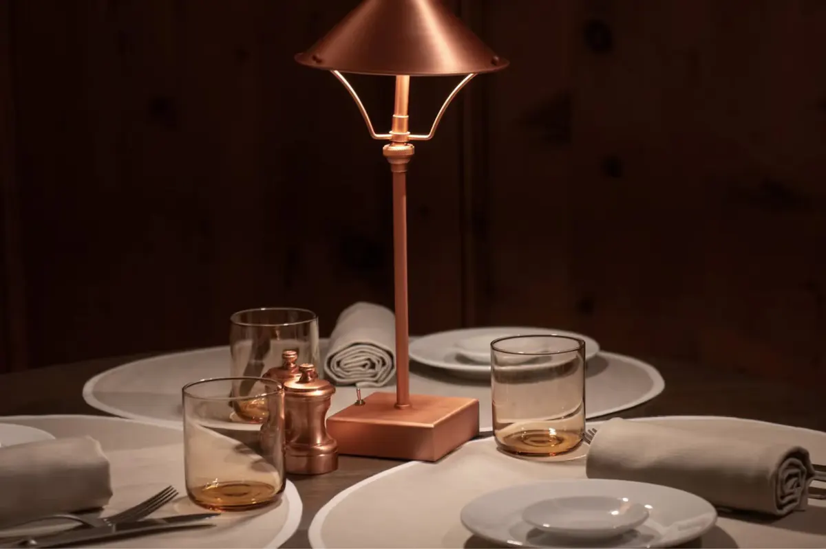 A dining table set with fine china and glassware overlooking the snow-covered landscape