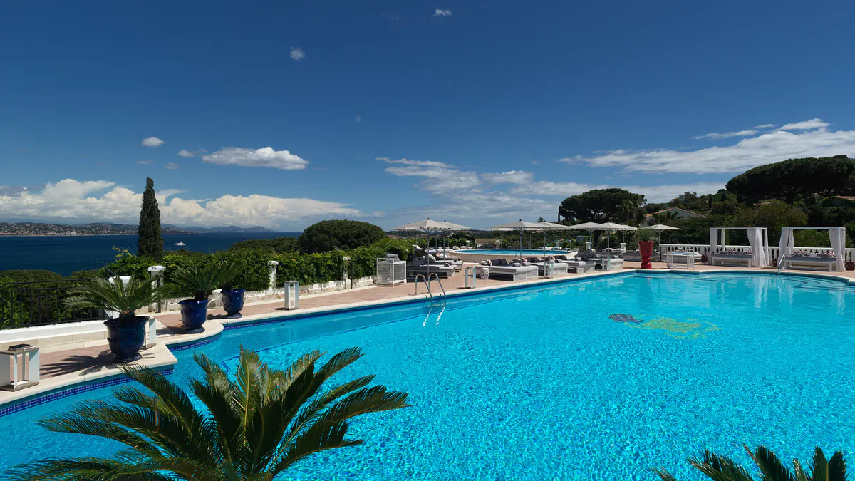 Blue lap pool and surrounding terraces with Mediterranean views