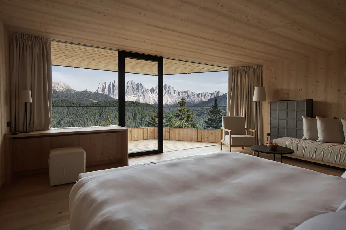 A spa treatment room with stone surfaces, wood elements, and a minimalist layout for wellness services