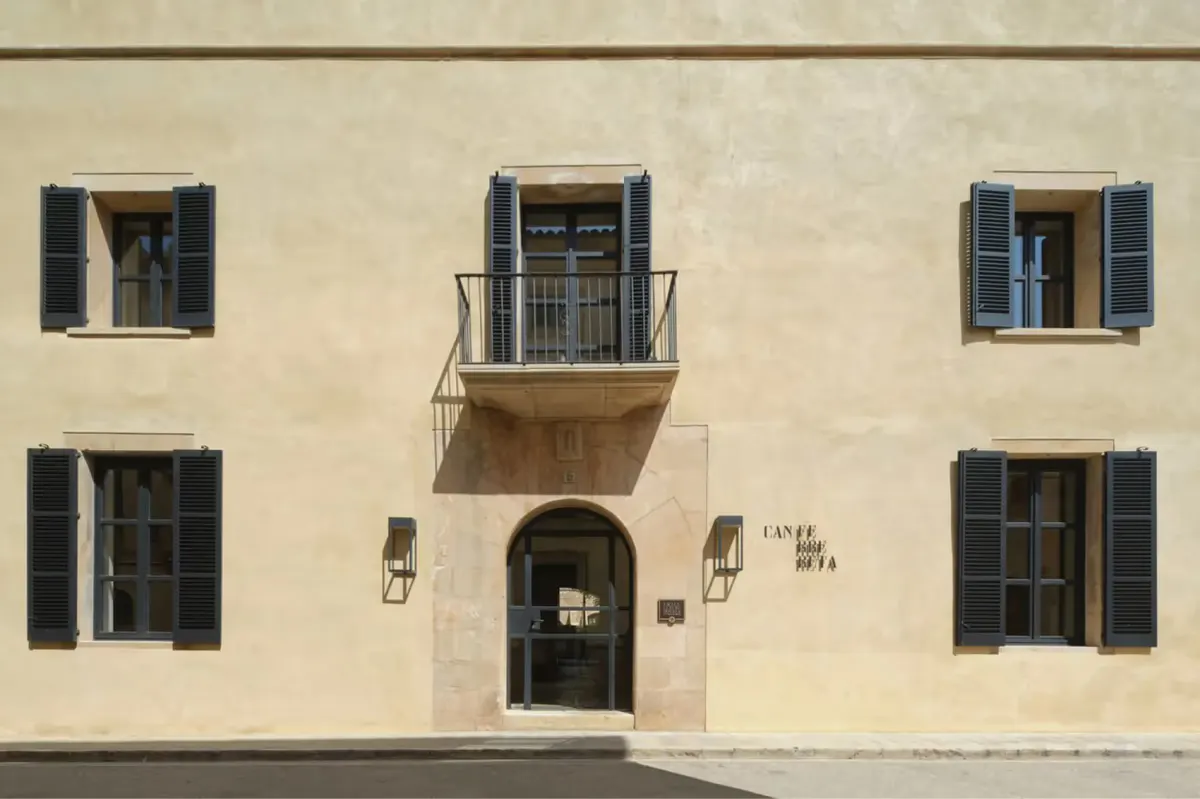 Exterior facade with traditional stone architecture and dark shutters