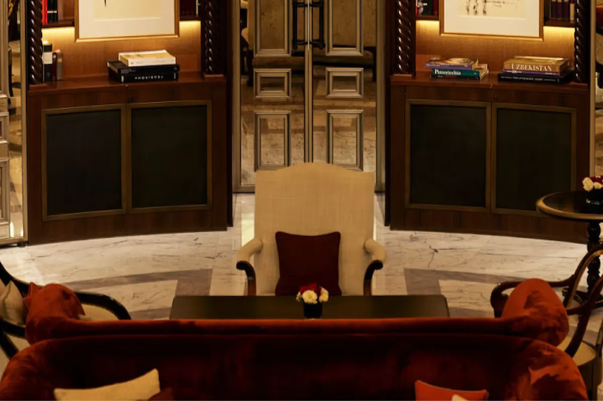 A lounge area with dark wood cabinetry, fireplace, and decorative shelving with books and objects