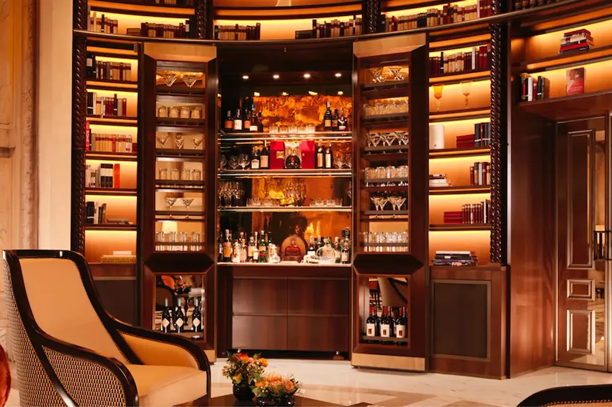 La Libreria lounge with wooden display cabinets, elegant furnishings, and warm lighting