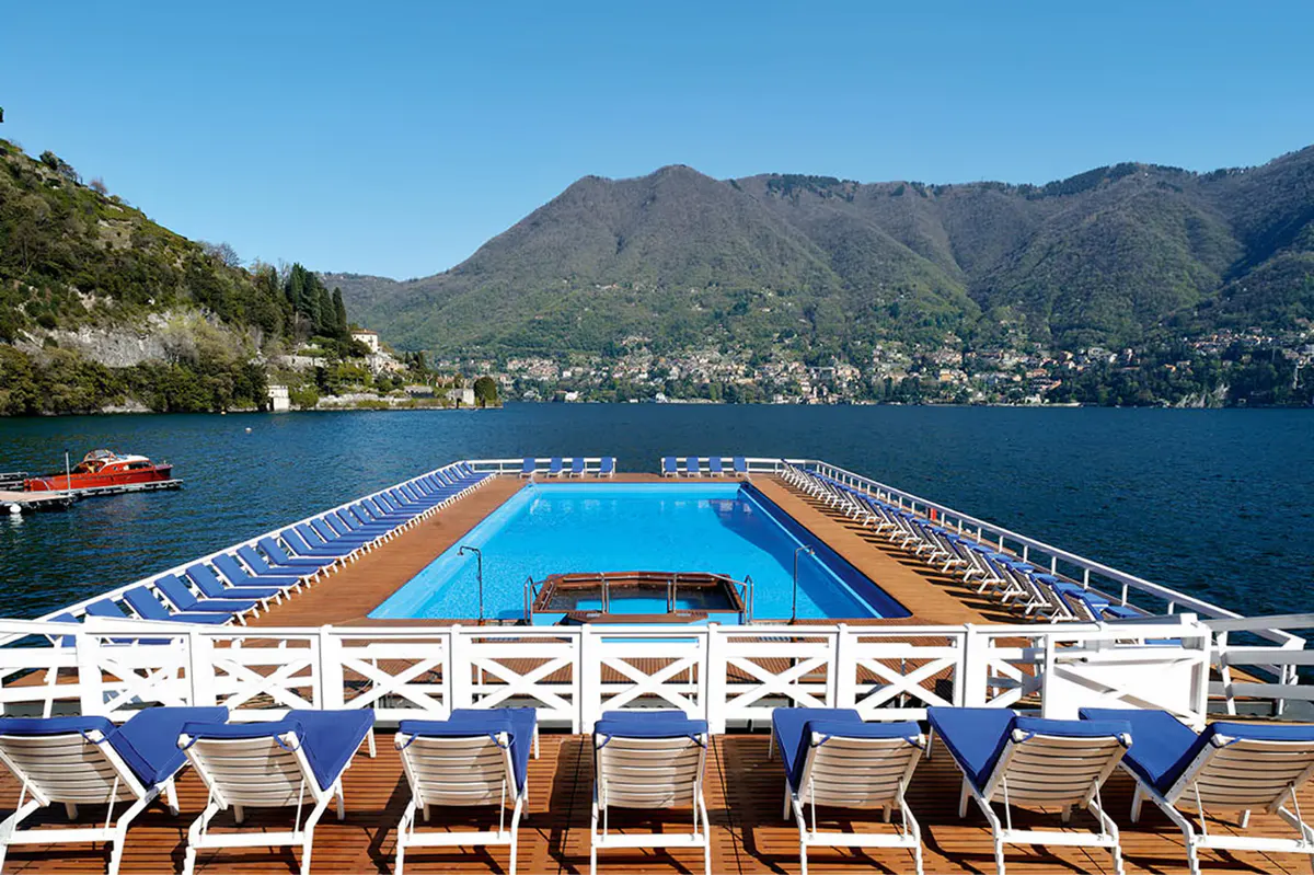 Floating blue pool platform anchored in the lake water