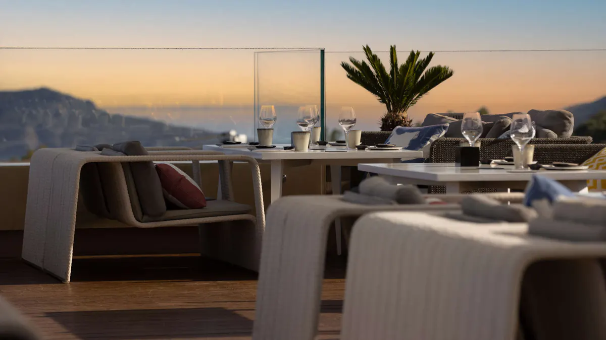 Restaurant interior with dining tables and mountain views
