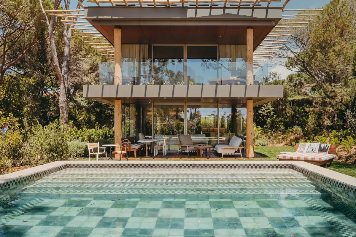 Two-story villa with pool featuring teal and white tile design