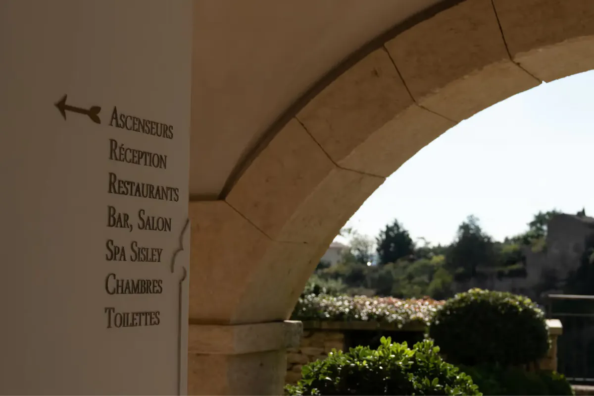 Stone facade with arched opening and outdoor terrace