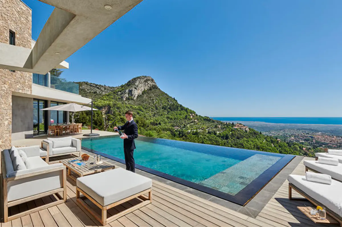 Clifftop villa terrace with heated infinity pool and sea views