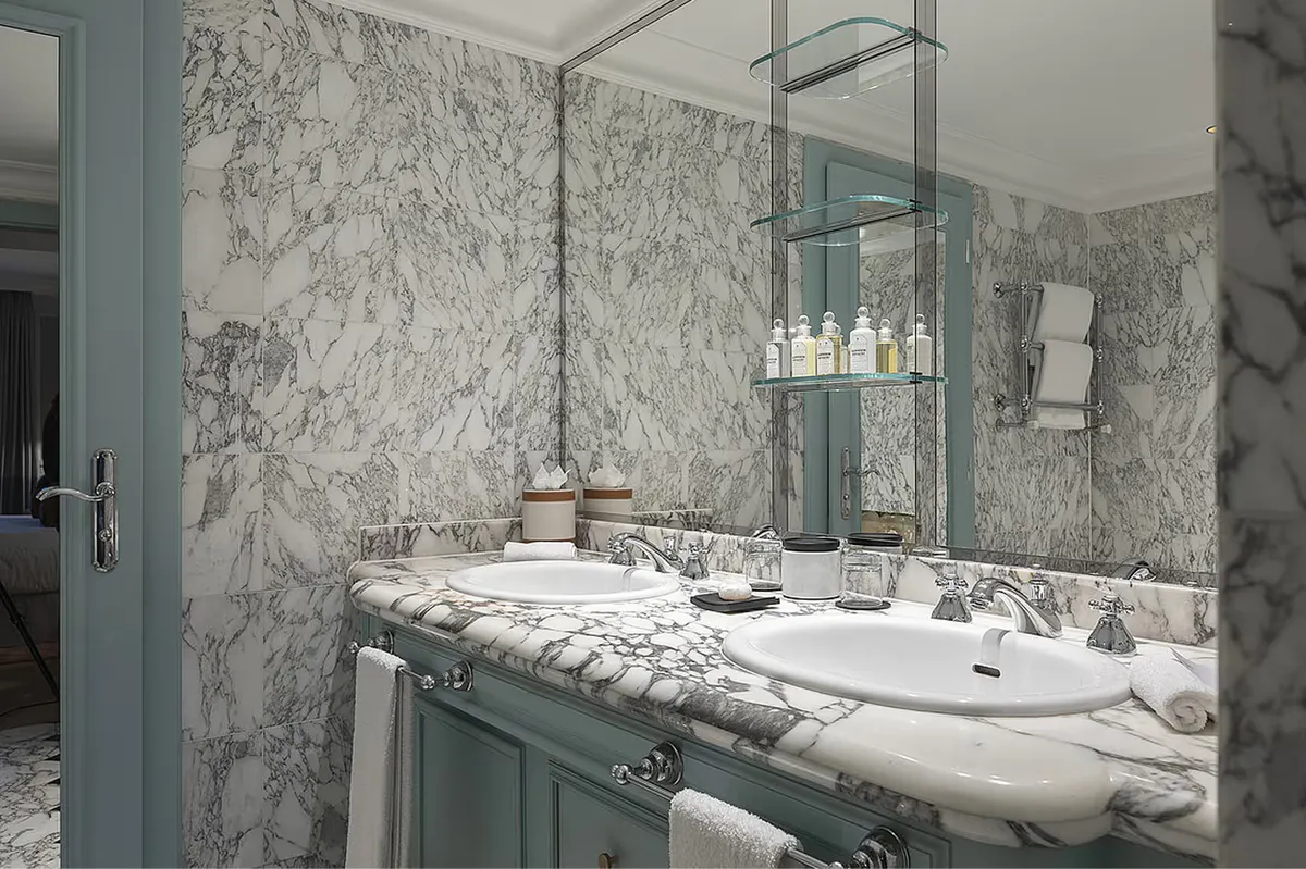 Marble-clad ensuite with double vanity and large mirror