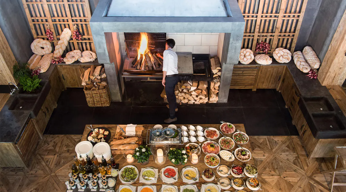 Overhead view of a dining area with fireplace and multiple plated courses