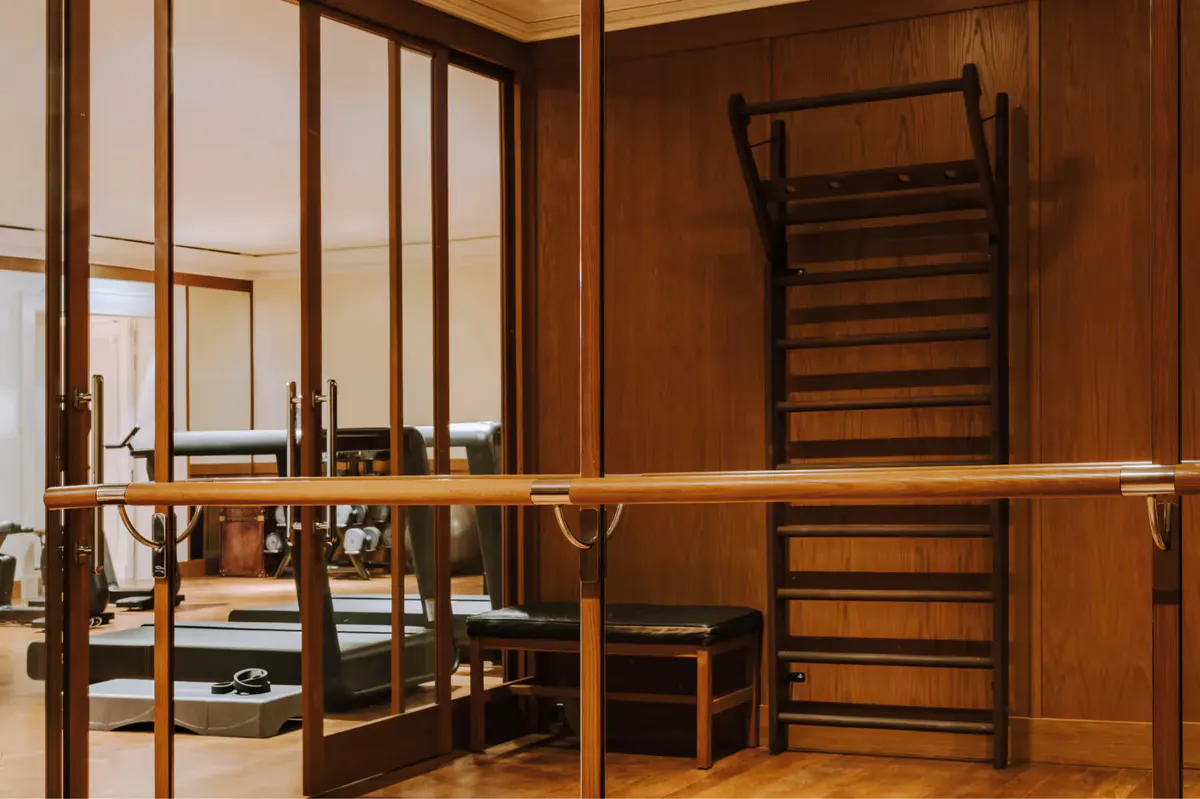 Spa facility with arched entryway, wood paneling, and dressing area