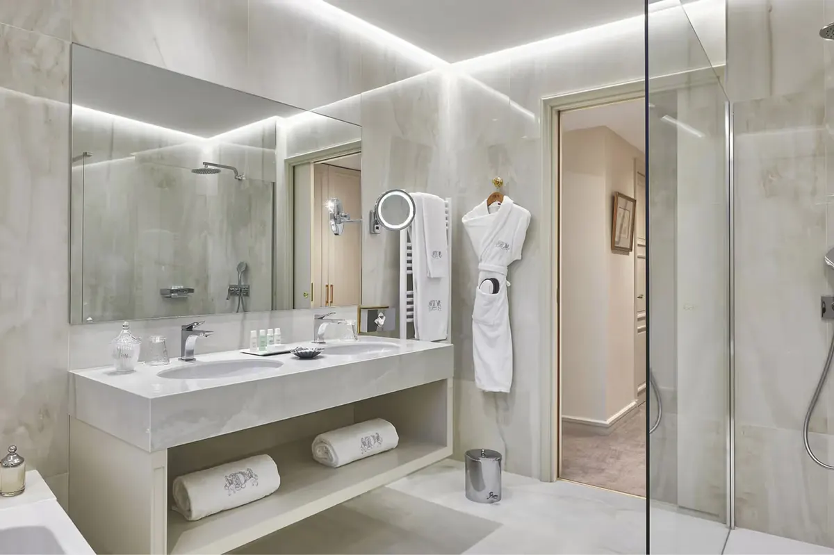Bathroom with floating vanity, large mirror, and modern fixtures