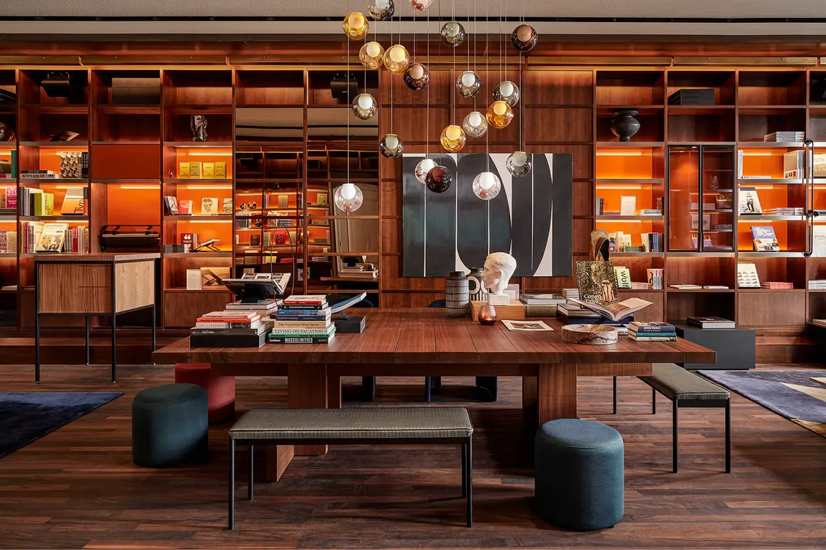 Library wall with extensive book collection, wood shelving, and reading furniture