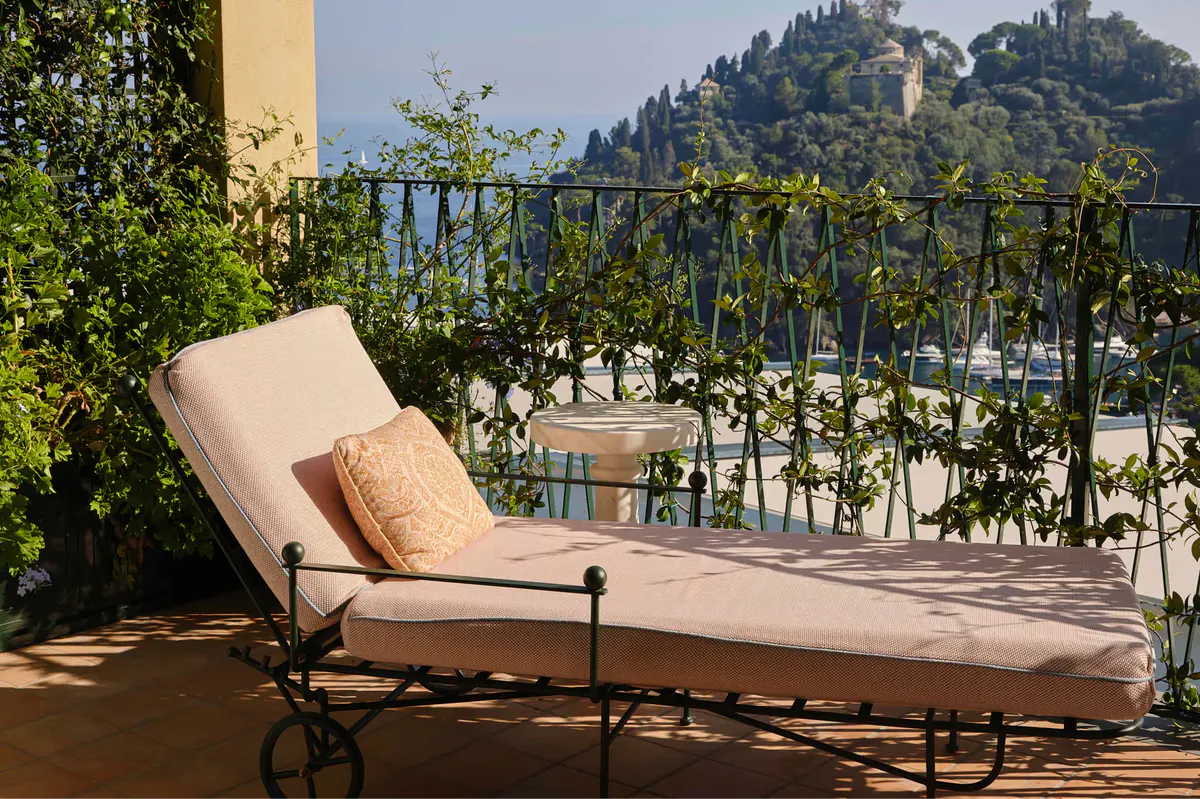 A balcony lounge area with upholstered seating and unobstructed sea vista