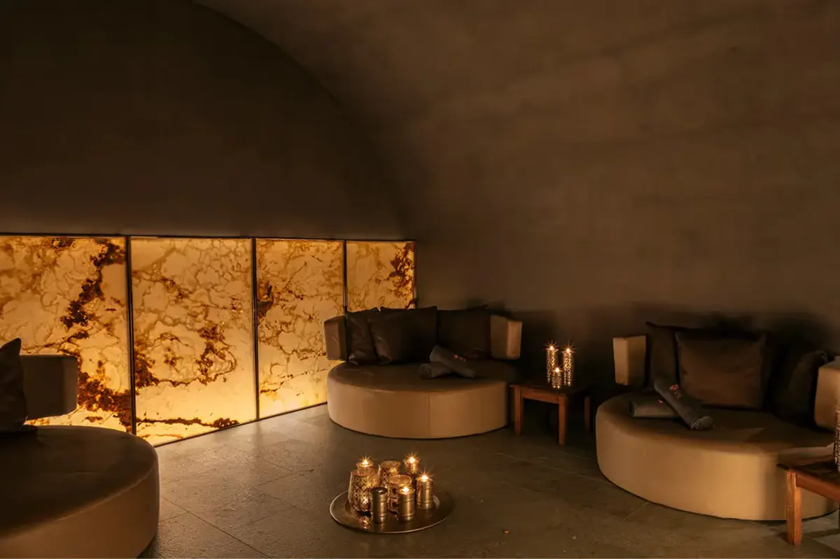 Spa treatment room with curved seating and amber ambient lighting