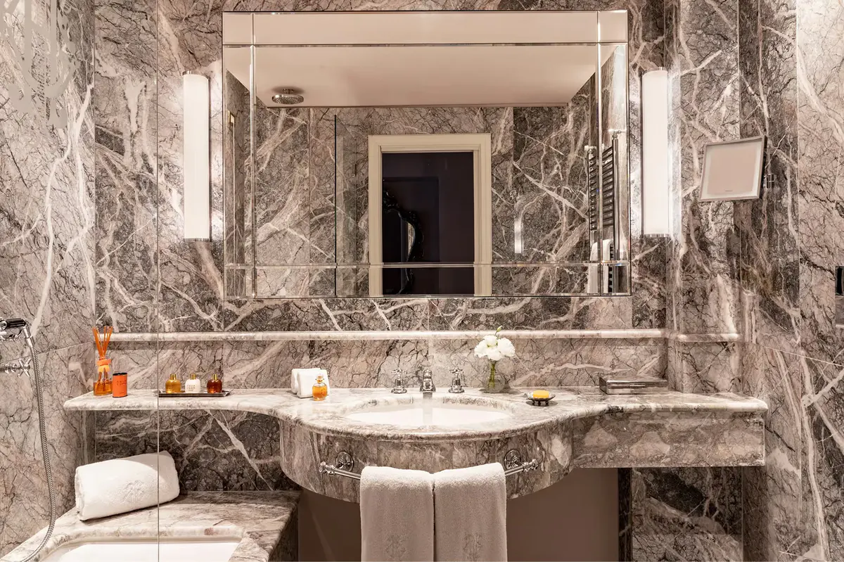 Luxe marble bathroom with double vanity and vessel sink basin