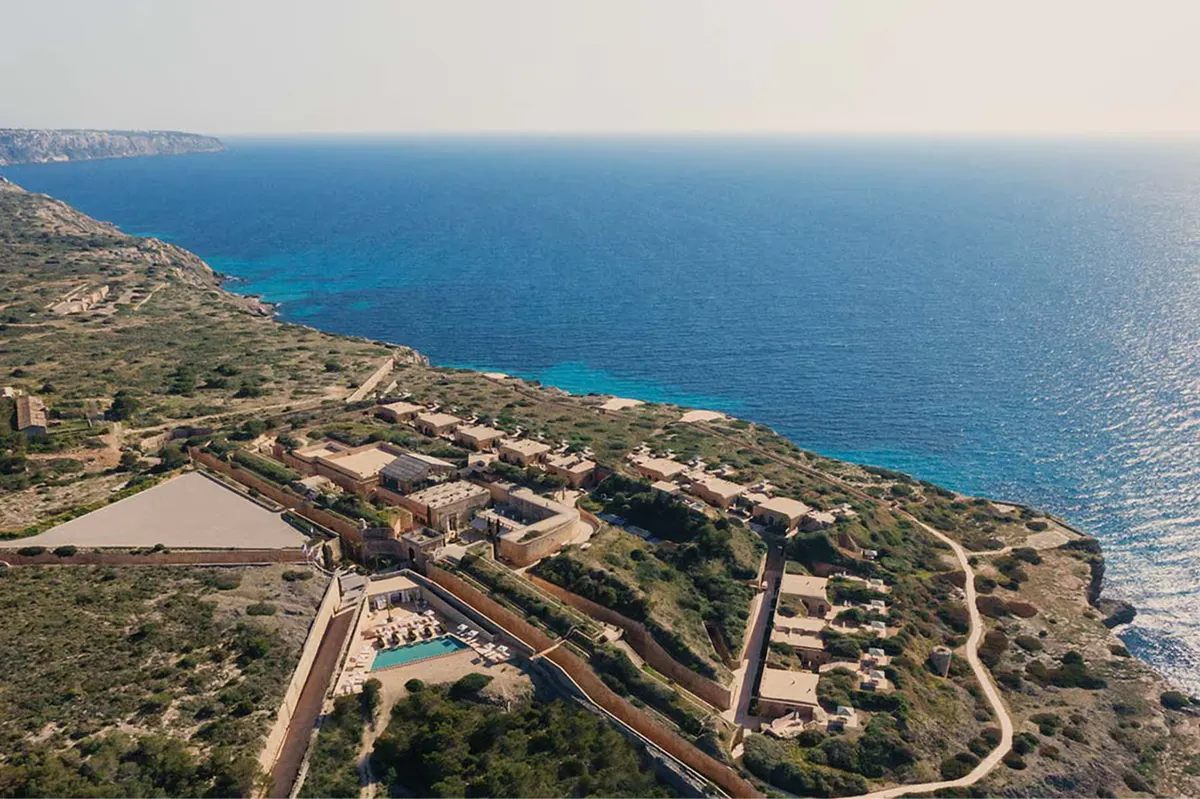 An aerial view of the fortress and coastline terraces integrated into the natural reserve