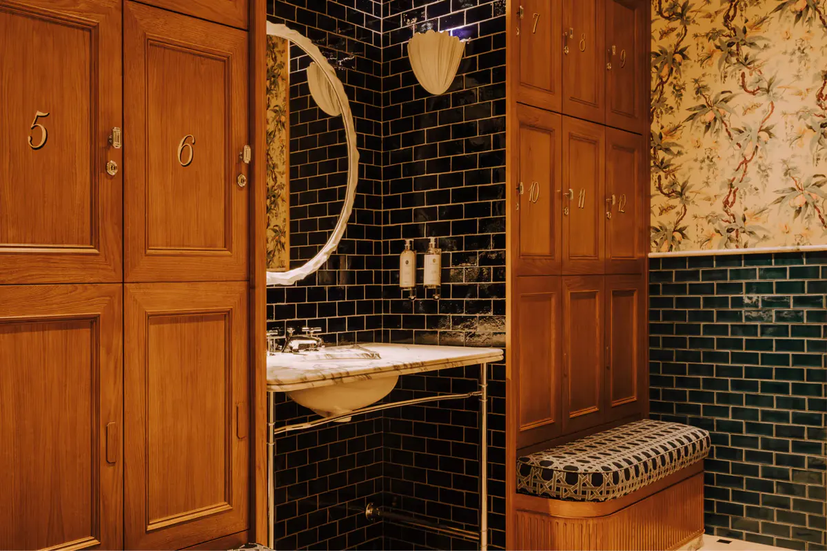 Spa interior with wood paneling, chrome ladder towel rack, and mirror detail