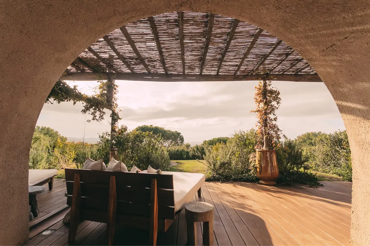 Sheltered terrace with wooden loungers overlooking forested hills